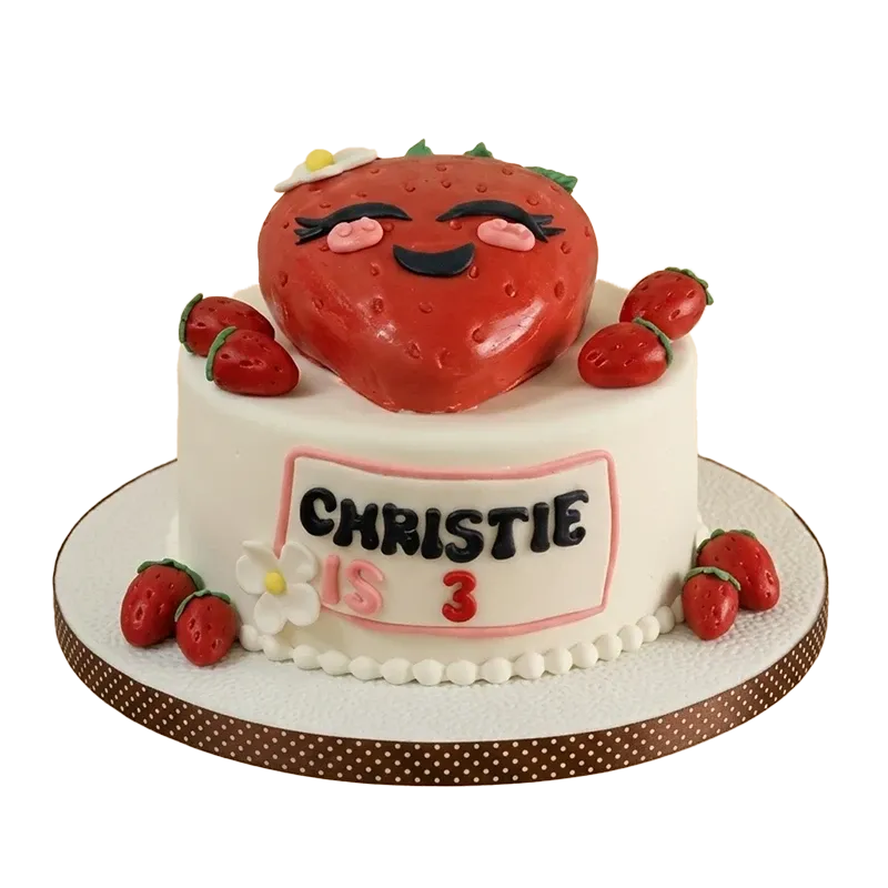 Kawaii strawberry birthday cake with smiling strawberry character figure, fresh strawberry accents, and Christie is 3 inscription