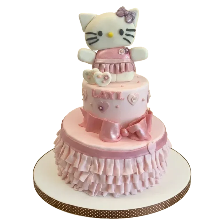 Two-tier pink Hello Kitty birthday cake with sculpted Hello Kitty figure, ruffled tiers, and Layla name inscription