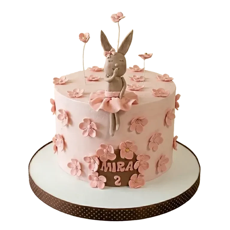 Pink ballerina bunny birthday cake with bunny ballerina figure, pink blossom flowers, and Mira 2 inscription