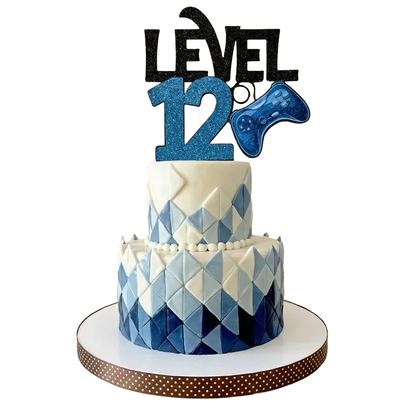 Two-tier geometric gamer birthday cake with blue diamond pattern and Level 12 game controller topper