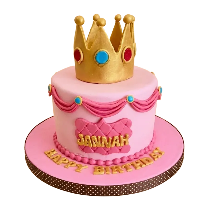 Pink royal princess birthday cake with gold crown topper, jewel accents, and Jannah Happy Birthday inscription