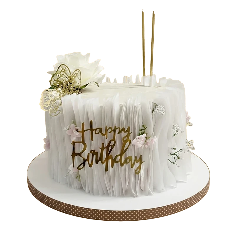 White ruffle-textured birthday cake with gold butterfly, pink mini roses, and gold script