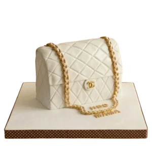 Birthday cake sculpted as a white quilted Chanel handbag with gold chain strap and CC logo