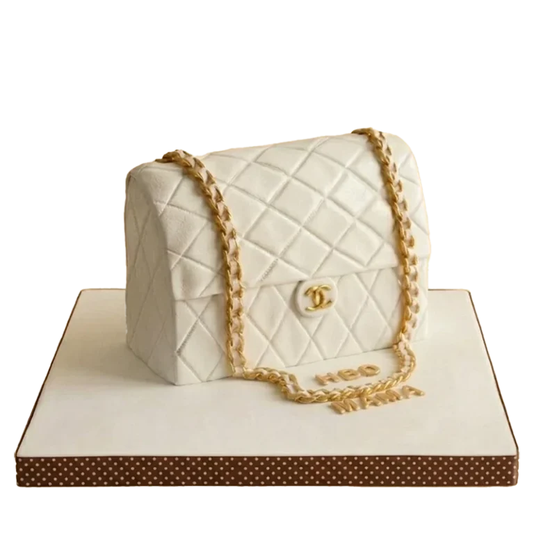 Birthday cake sculpted as a white quilted Chanel handbag with gold chain strap and CC logo