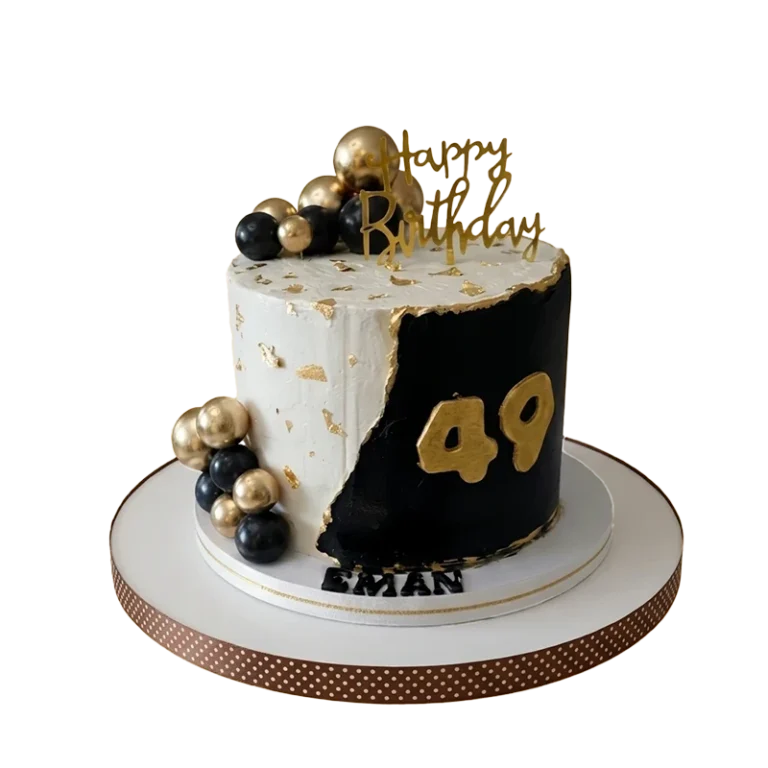 Black and white 49th birthday cake with gold leaf, gold and black spheres, and gold number