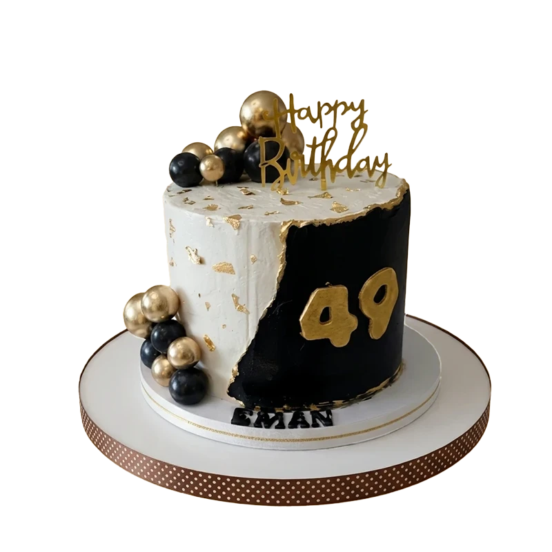 Black and white 49th birthday cake with gold leaf, gold and black spheres, and gold number