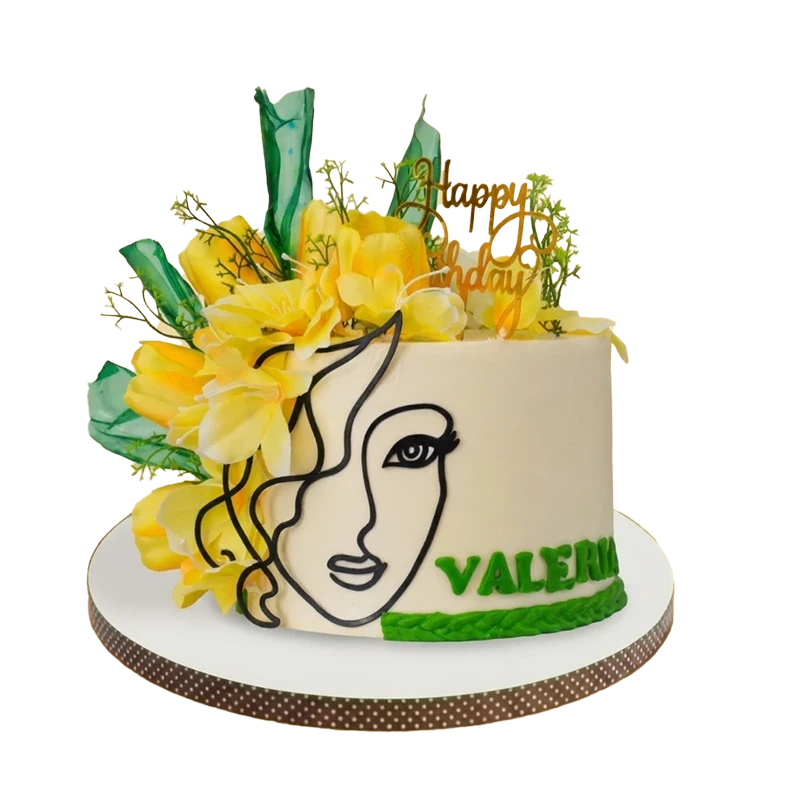 White birthday cake with artistic female face silhouette, yellow flowers, and green tropical leaves