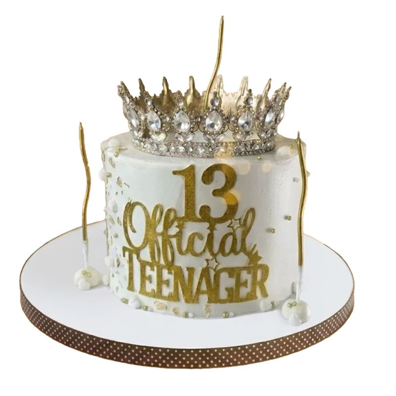 White 13th birthday cake with diamond crown topper and Official Teenager gold inscription