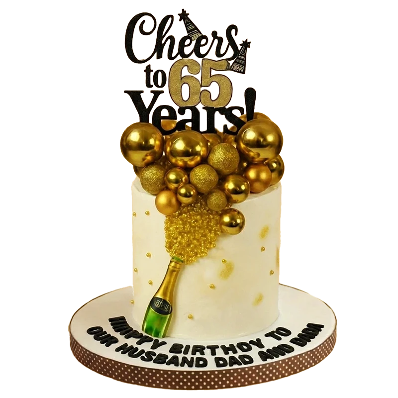 White 65th birthday cake with champagne bottle, gold sphere burst, and Cheers to 65 Years topper