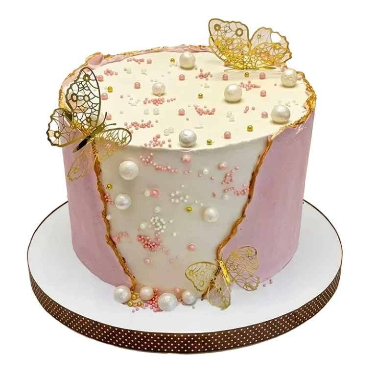Pink and white birthday cake with gold filigree butterflies, white pearls, and gold veining