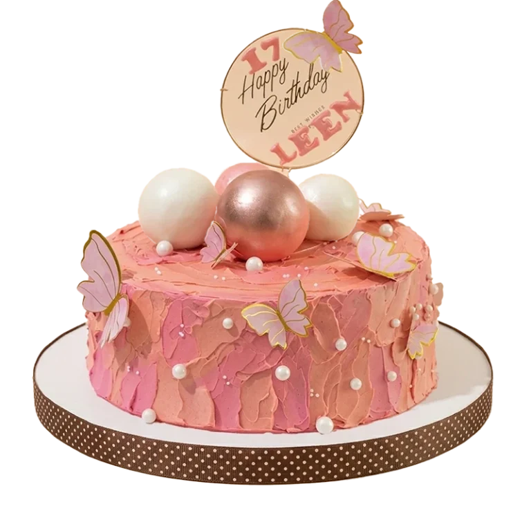 Textured coral pink 17th birthday cake with pink butterflies and rose gold sphere cluster topper