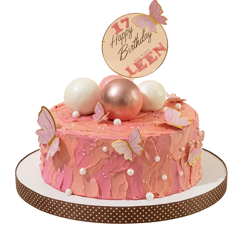 Textured coral pink 17th birthday cake with pink butterflies and rose gold sphere cluster topper