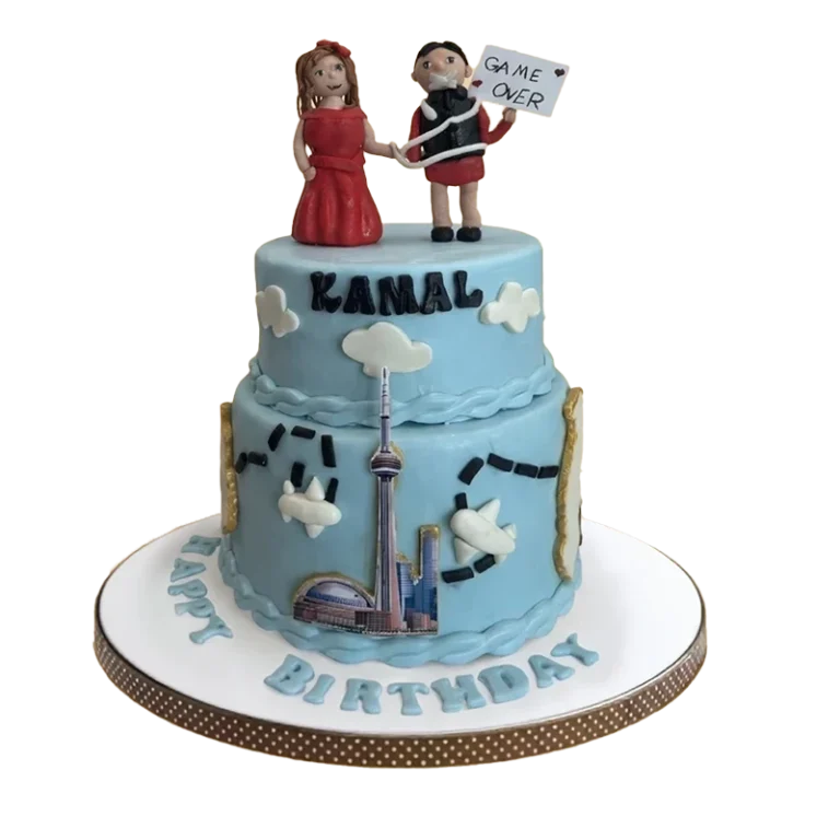 Two-tier blue Toronto skyline birthday cake with CN Tower, clouds, and bride groom figures