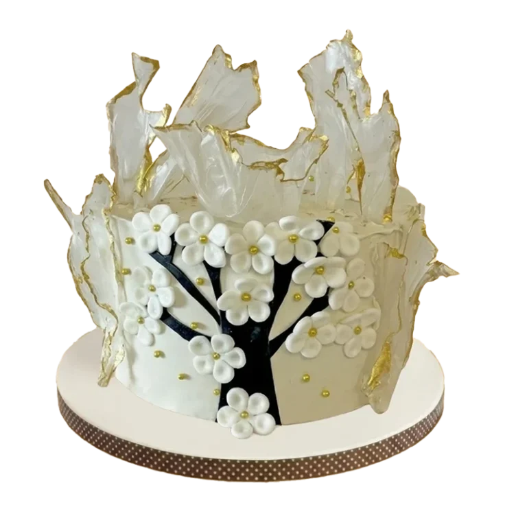 Elegant cake with white wafer paper sails, cherry blossom tree, and white flowers with gold centres