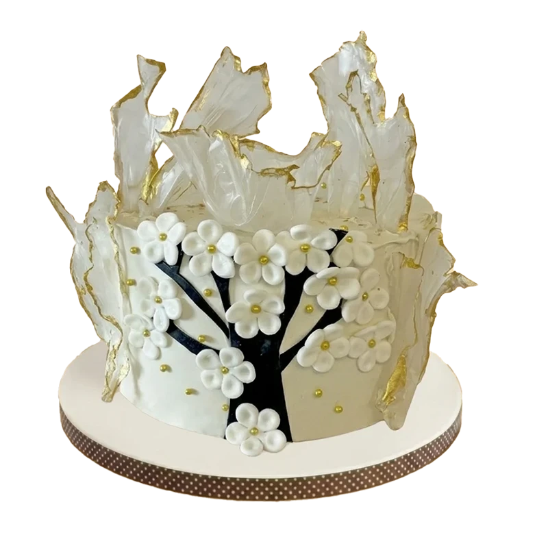 Elegant cake with white wafer paper sails, cherry blossom tree, and white flowers with gold centres