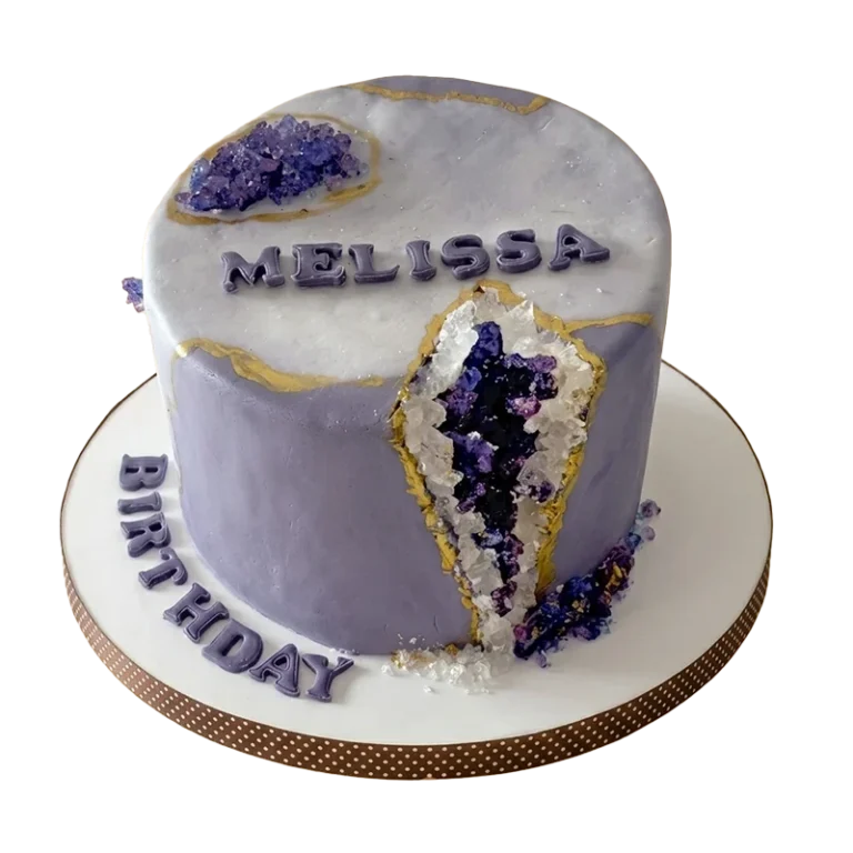 Purple amethyst geode birthday cake with crystal-encrusted geode slice and gold veining
