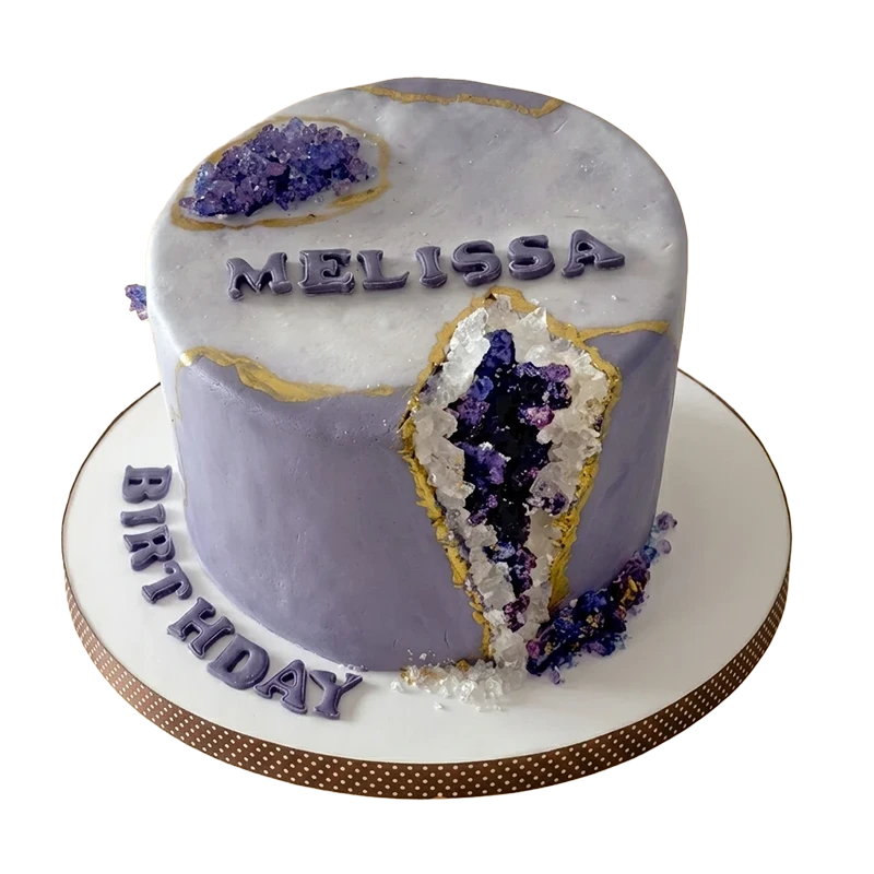 Purple amethyst geode birthday cake with crystal-encrusted geode slice and gold veining