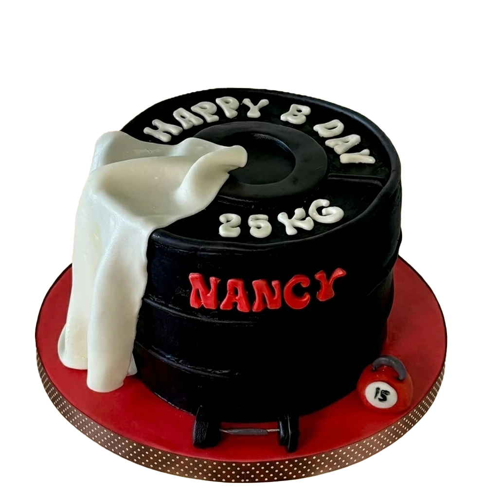 Gym-themed birthday cake shaped like a black 25kg weight plate with white towel drape