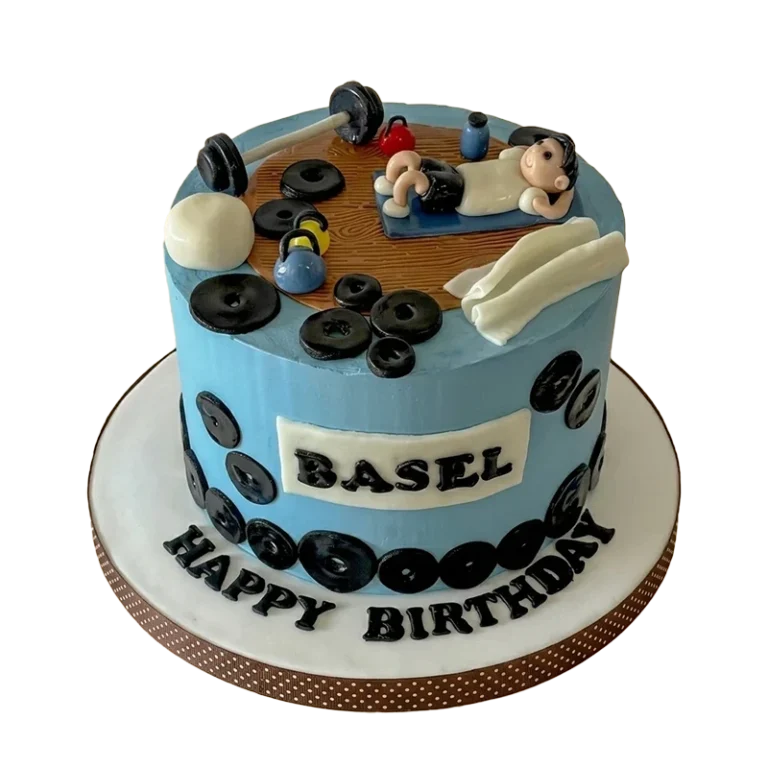 Blue gym-themed birthday cake with weight plates, dumbbells, and bench press figure topper