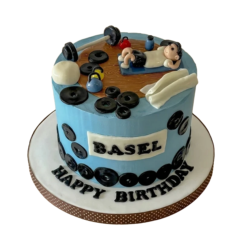 Blue gym-themed birthday cake with weight plates, dumbbells, and bench press figure topper