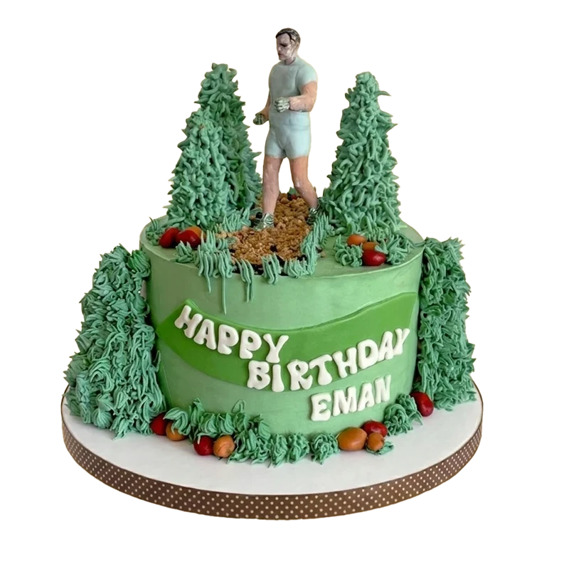 Green trail runner birthday cake with jogger figure, pine trees, and name inscription