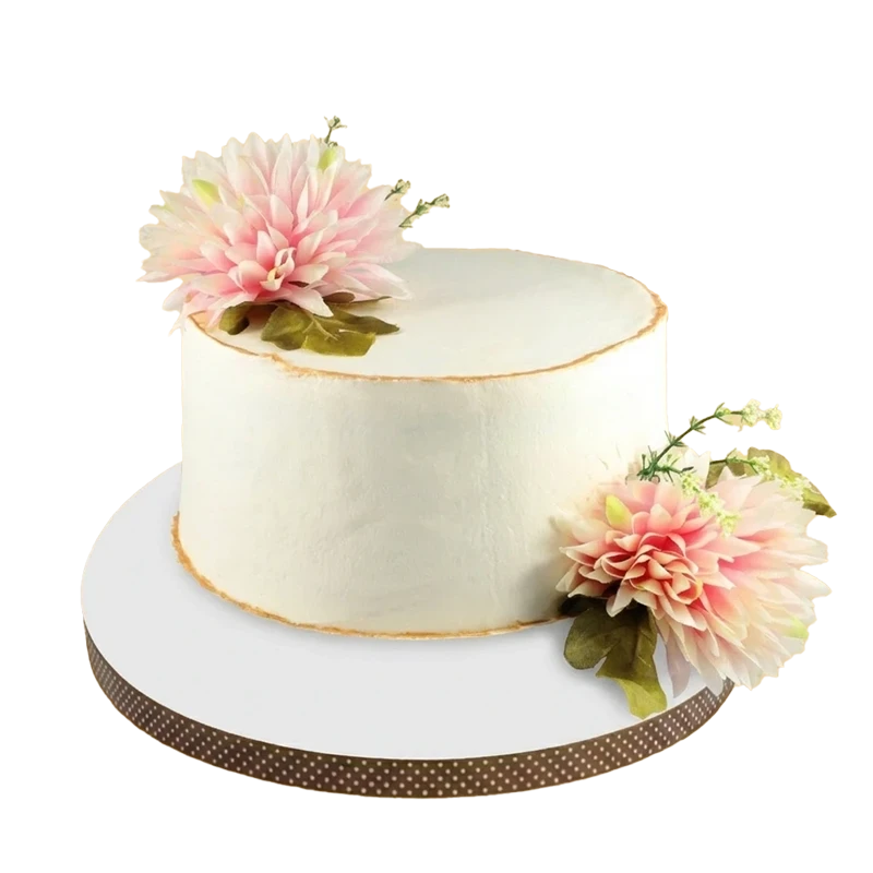 Minimalist white cake adorned with large pink dahlia flowers and green foliage