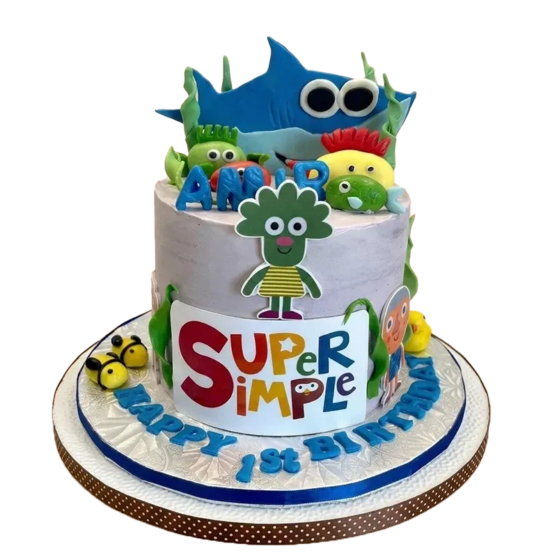 Two-tier first birthday cake with Super Simple Songs characters and Happy 1st Birthday inscription