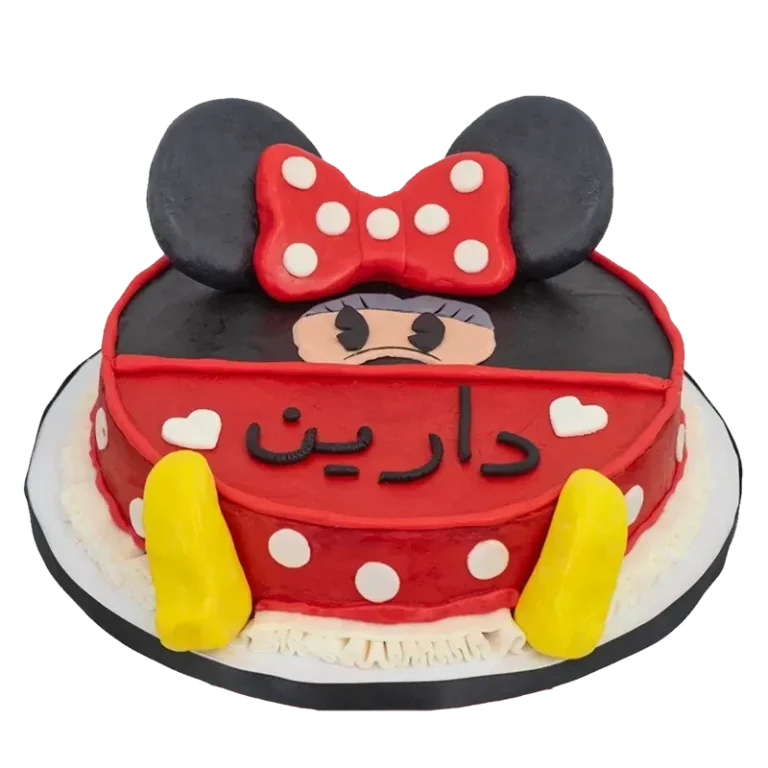 Classic Minnie Mouse birthday cake in red with polka dots, bow, and Arabic name inscription