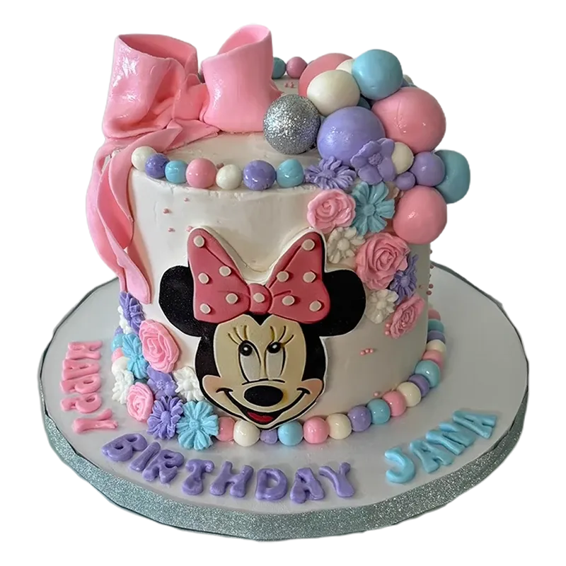 Whimsical Minnie Mouse birthday cake with pastel balloon clusters, pink bow, and floral decorations