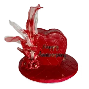 Red heart-shaped anniversary cake with Happy Anniversary inscription and crystal sugar decorations