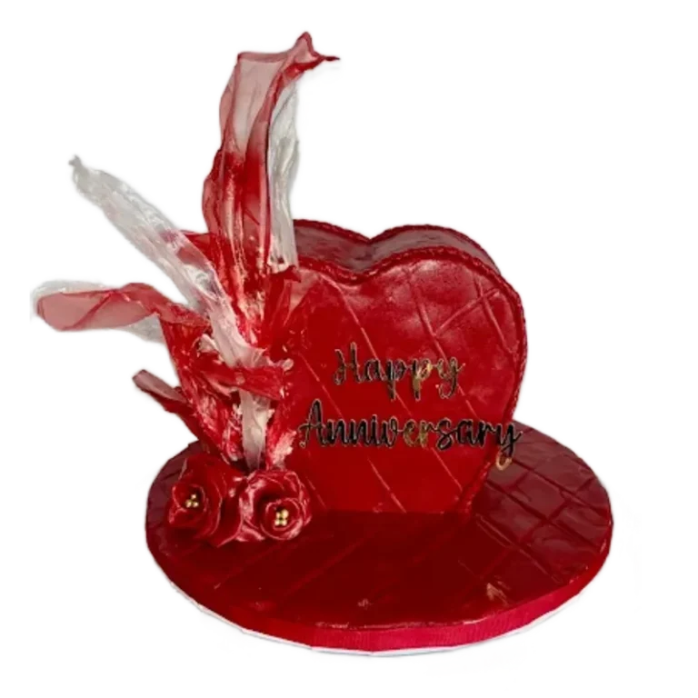 Red heart-shaped anniversary cake with Happy Anniversary inscription and crystal sugar decorations