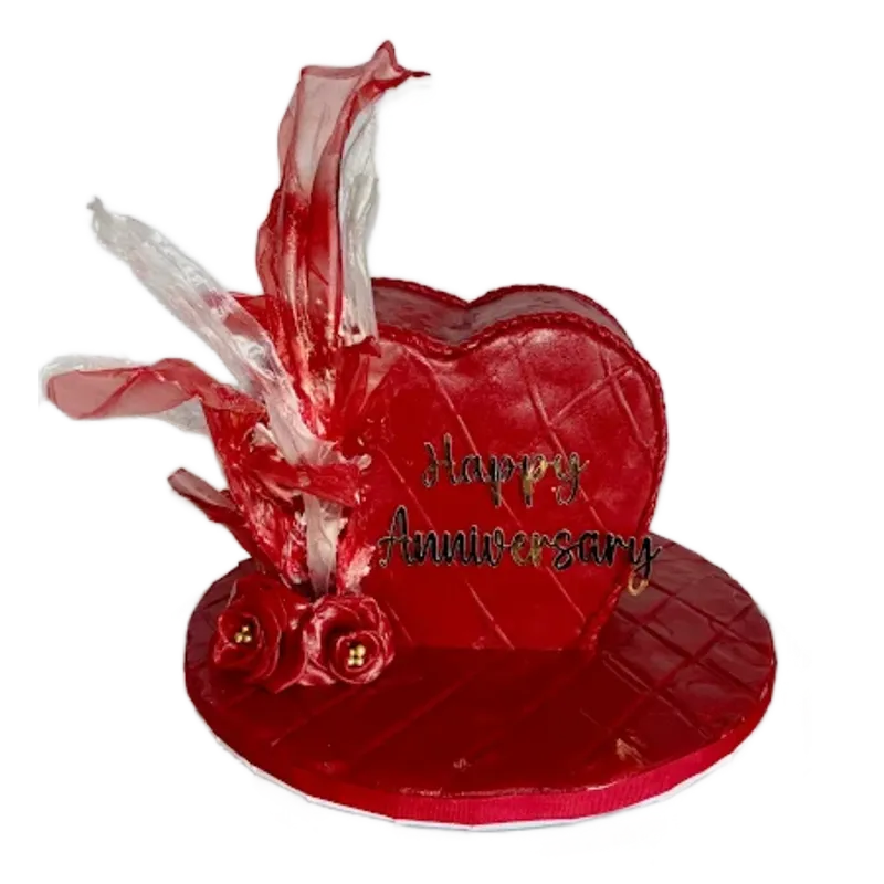 Red heart-shaped anniversary cake with Happy Anniversary inscription and crystal sugar decorations