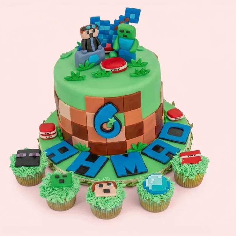 Minecraft birthday cake with green grass top, block body, Steve and Creeper toppers, and themed cupcakes