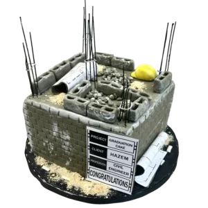 Civil engineering graduation cake shaped as concrete foundation with rebar rods and blueprint details