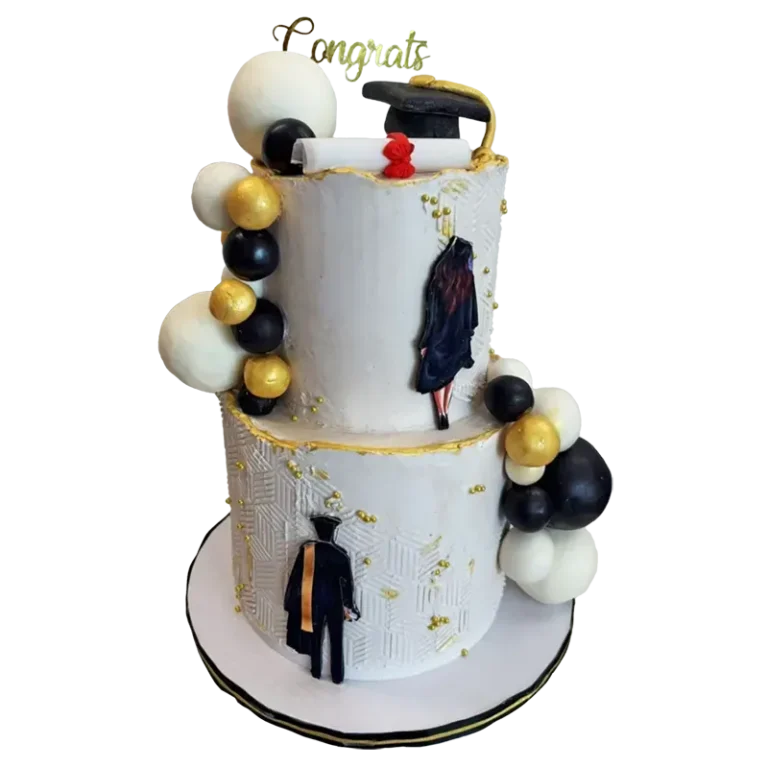 Two-tier white graduation cake with black and gold balloons, graduate figure, and Congrats topper