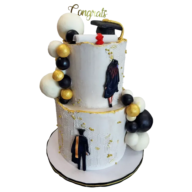 Two-tier white graduation cake with black and gold balloons, graduate figure, and Congrats topper
