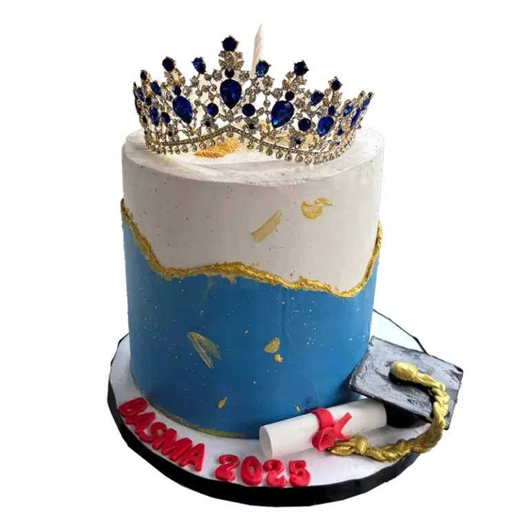 Royal Success graduation cake in blue and white with jeweled crown topper and diploma decorations