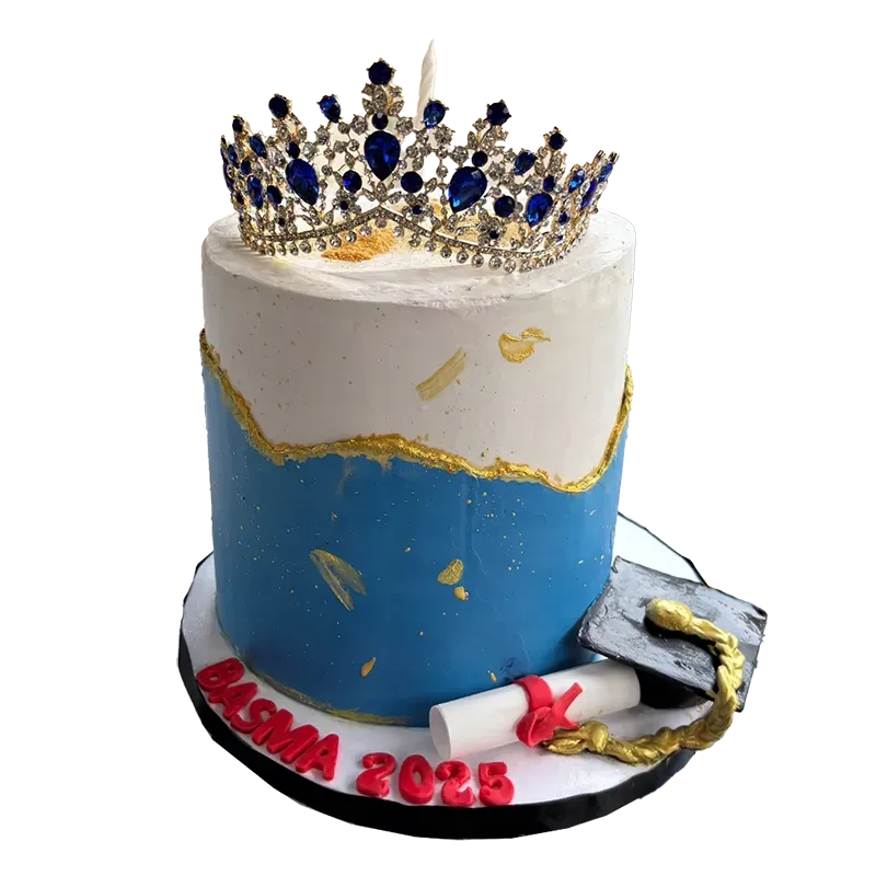 Royal Success graduation cake in blue and white with jeweled crown topper and diploma decorations