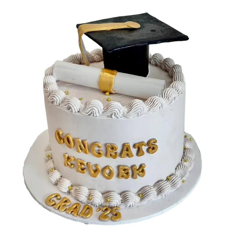 White graduation cake with gold cap and diploma topper and Congrats Grad gold letter inscription