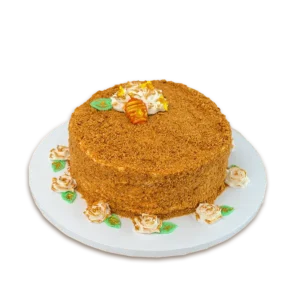 Golden Honey Medovik cake with honey crumb coating, cream roses, and small honeycomb topper
