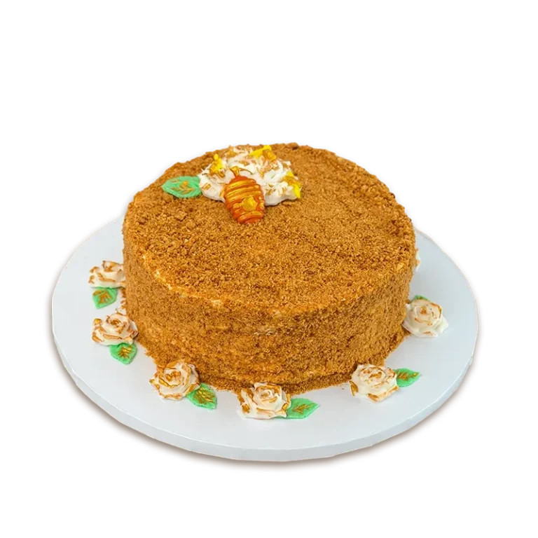 Golden Honey Medovik cake with honey crumb coating, cream roses, and small honeycomb topper