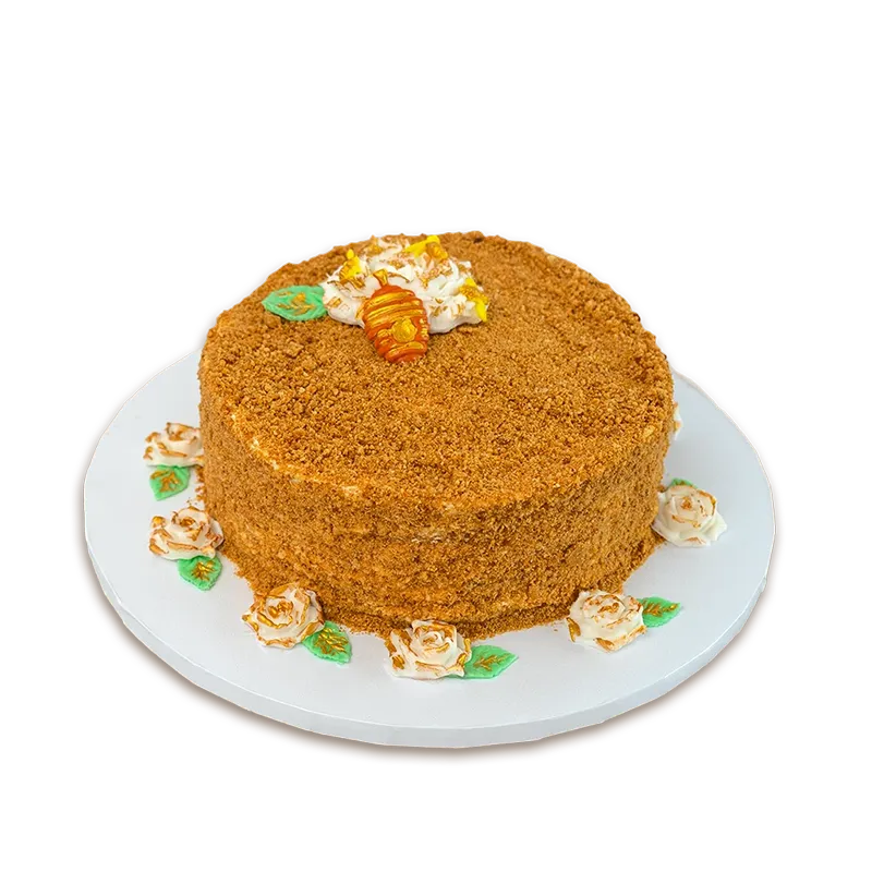 Golden Honey Medovik cake with honey crumb coating, cream roses, and small honeycomb topper