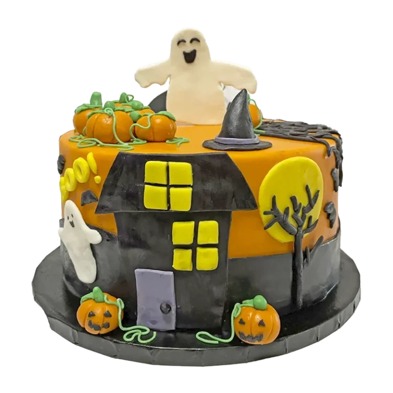 Halloween haunted house cake with ghost topper, pumpkins, witch hat, and spooky tree in orange and black