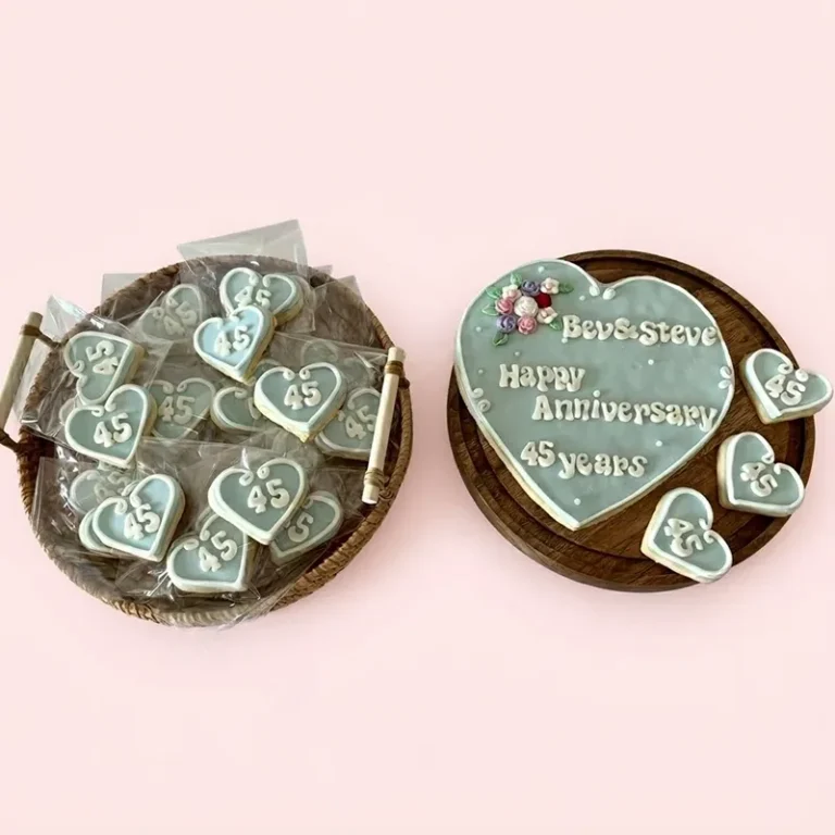 Sweet Sapphire blue heart-shaped 45th anniversary cookies with floral accents and Happy Anniversary inscription