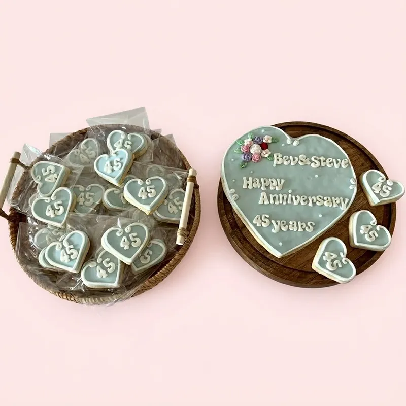Sweet Sapphire blue heart-shaped 45th anniversary cookies with floral accents and Happy Anniversary inscription