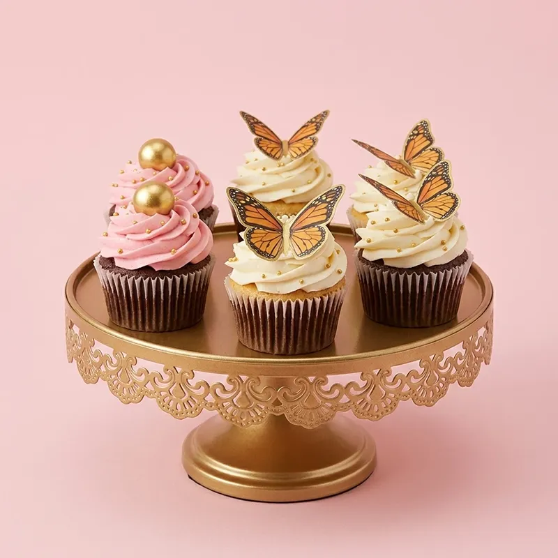 Gilded Monarchs cupcakes with monarch butterfly toppers and gold pearls on a gold stand