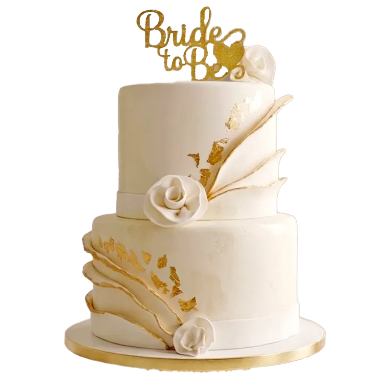 Two-tier white wedding cake with gold leaf, white rose, and Bride to Be topper