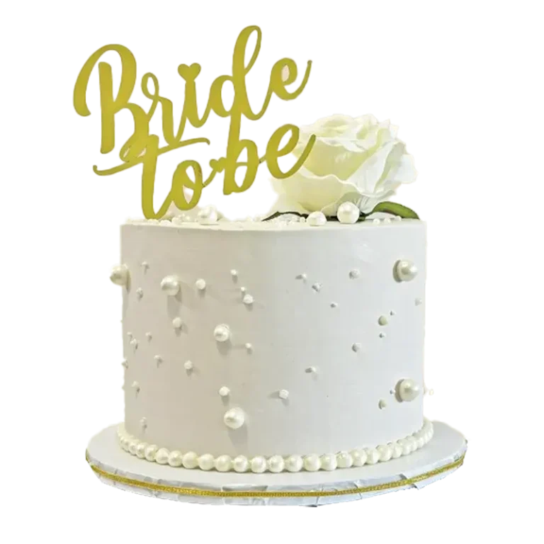 Pearl Perfection white bridal shower cake with scattered pearls, white rose, and Bride to Be topper
