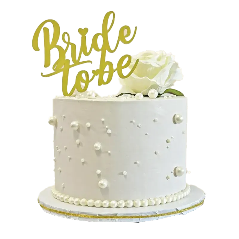 Pearl Perfection white bridal shower cake with scattered pearls, white rose, and Bride to Be topper
