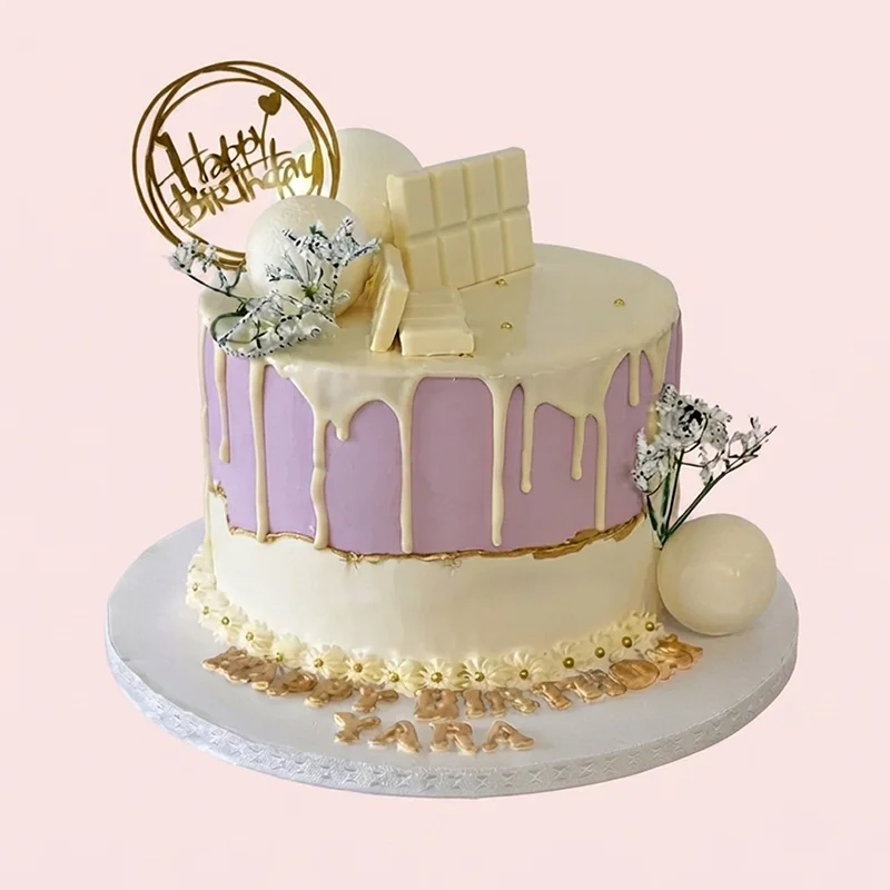 Lavender birthday cake with white chocolate drip and gold accents by Cakeville Scarborough